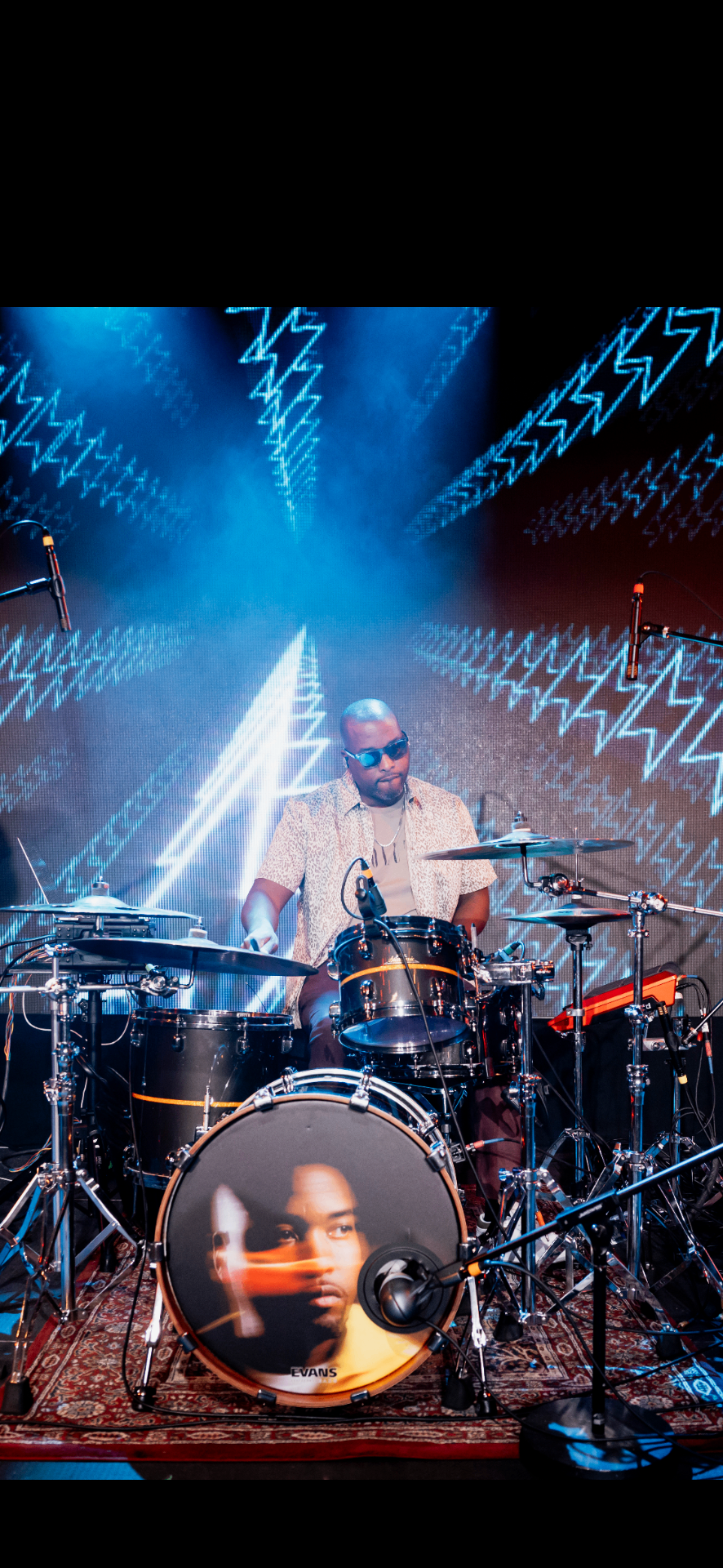 Drummer with a lightning visual backdrop