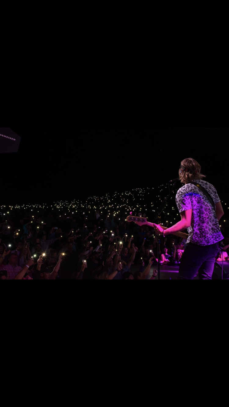 Stage view of a crowd holding phone lights